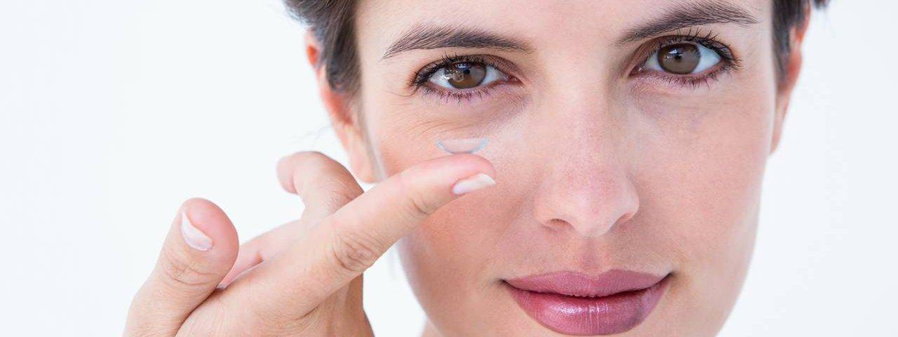 woman holding contact lens